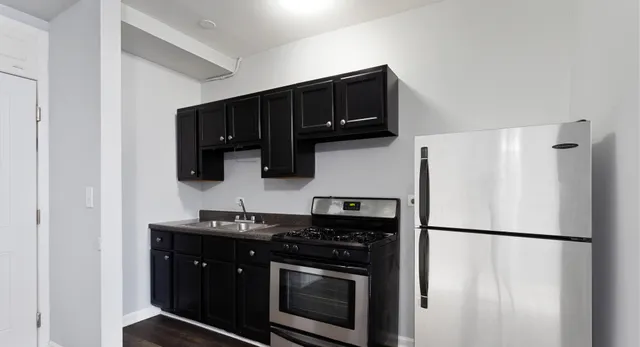 a kitchen with a refrigerator stove and microwave