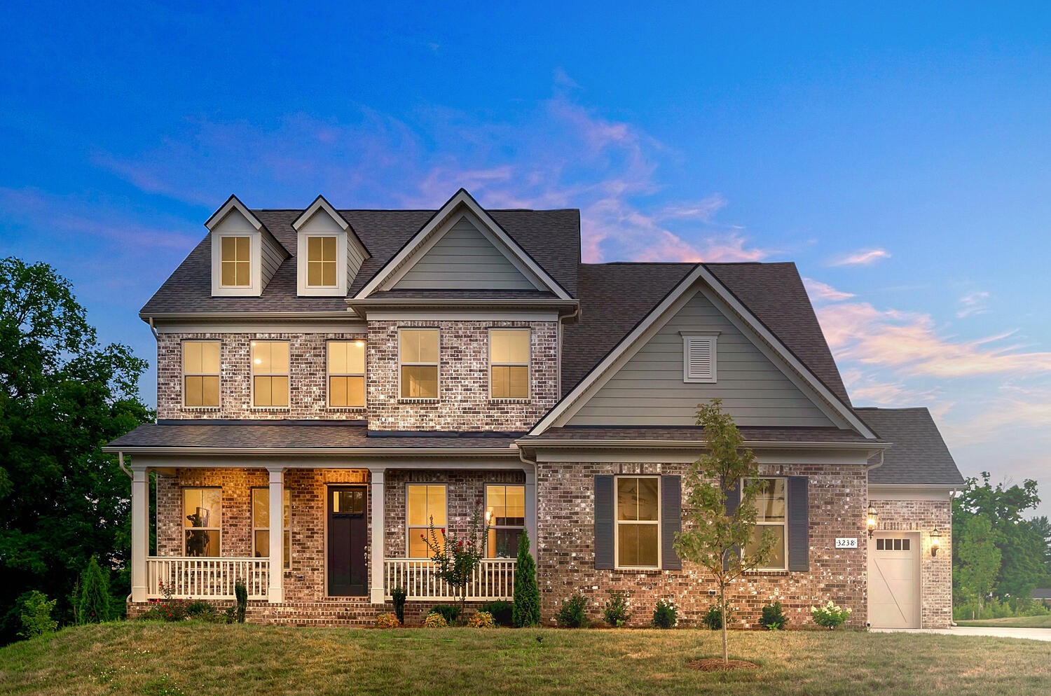 a front view of a house with a yard