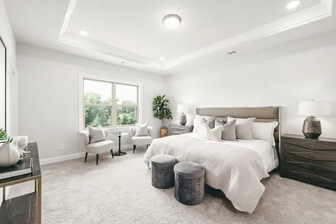 a bedroom with bed and a large window