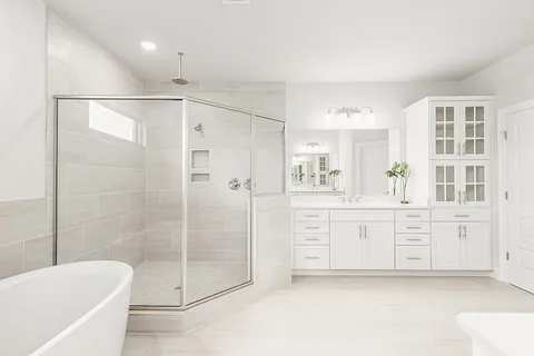a bathroom with a shower a sink a mirror and a bathtub