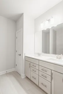 a bathroom with a double vanity sink mirror and