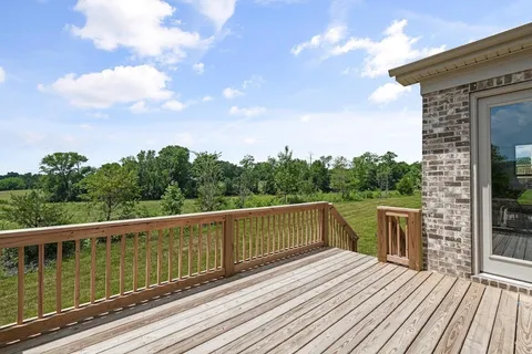 a view of a wooden deck with a yard
