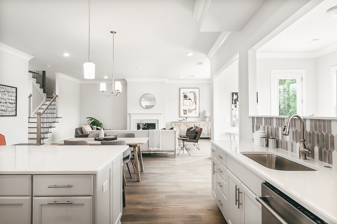 3238 Chase Point Drive Franklin, TN 37067 - Photo 6 of 29 a open kitchen with stainless steel appliances kitchen island a white counter space a sink and living room view