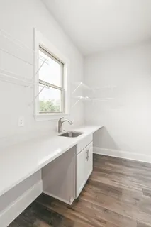 a utility room with cabinets washer and dryer