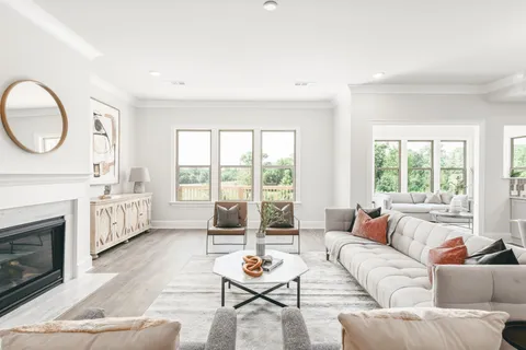 a living room with furniture a fireplace and a large window