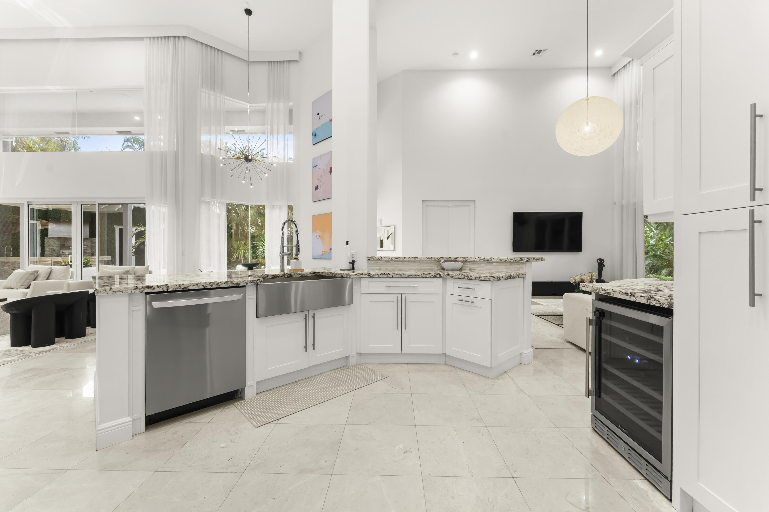 3156 Northwest 61st Street Boca Raton, FL 33496 - Photo 13 of 46 a large white kitchen with a stove a sink dishwasher and a refrigerator with wooden floor