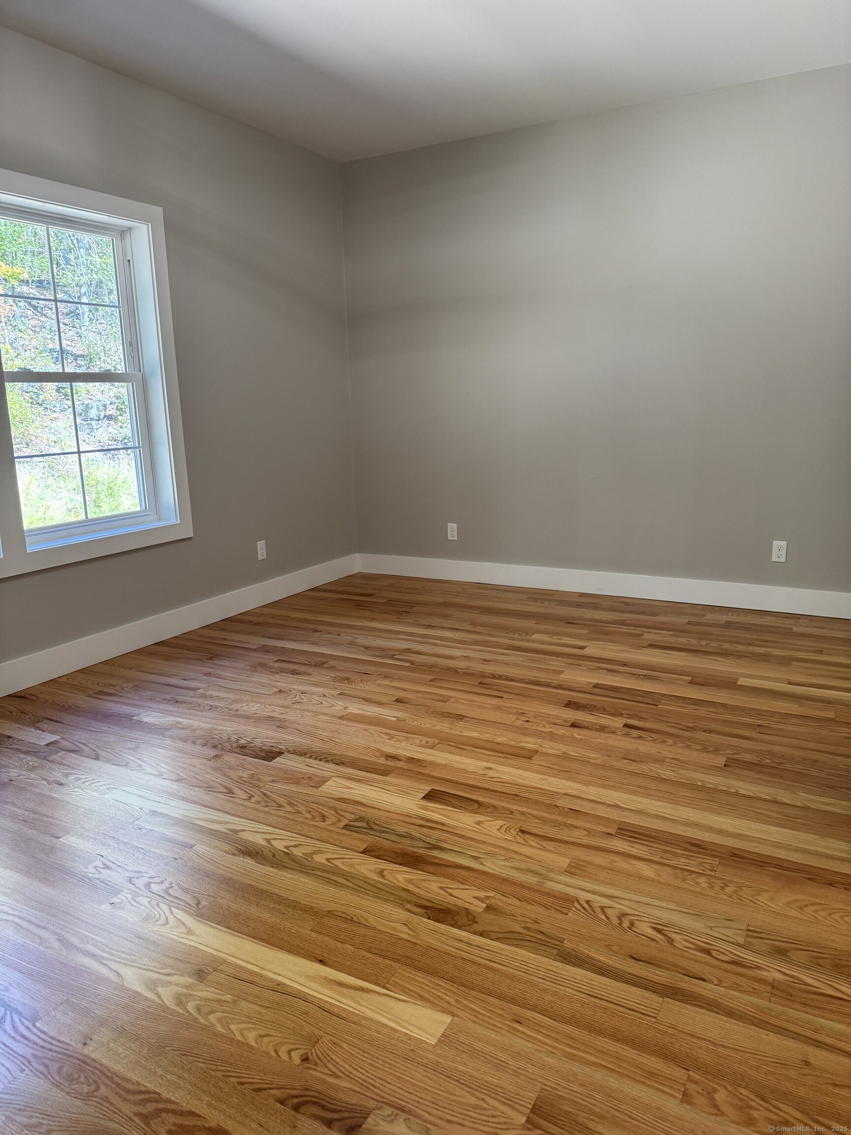 243 Echo Lake Road, Unit B8 Watertown, CT 06795 - Photo 11 of 11 an empty room with wooden floor and windows