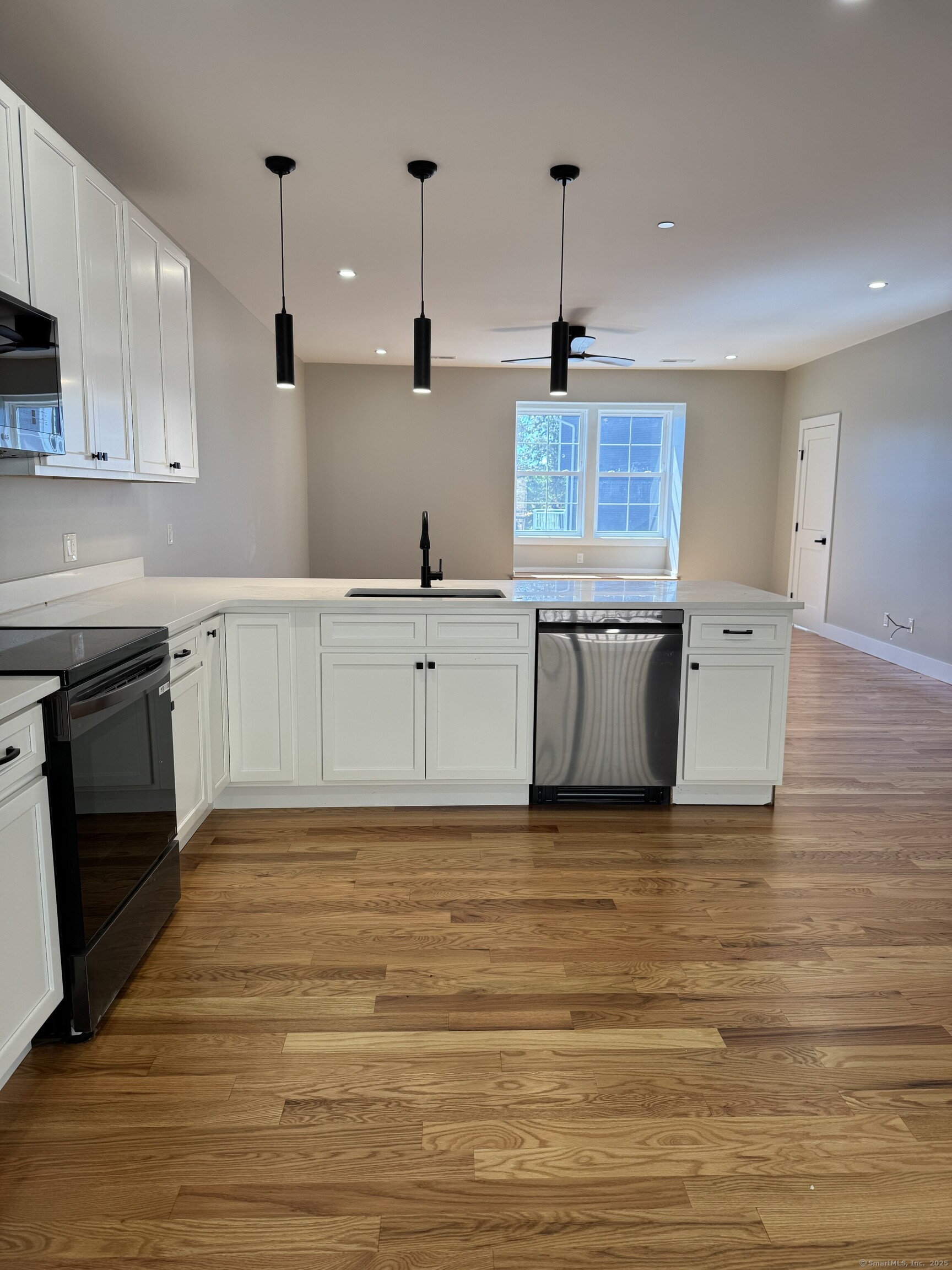 243 Echo Lake Road, Unit B8 Watertown, CT 06795 - Photo 2 of 11 a kitchen with stainless steel appliances granite countertop a sink a stove and a wooden floors