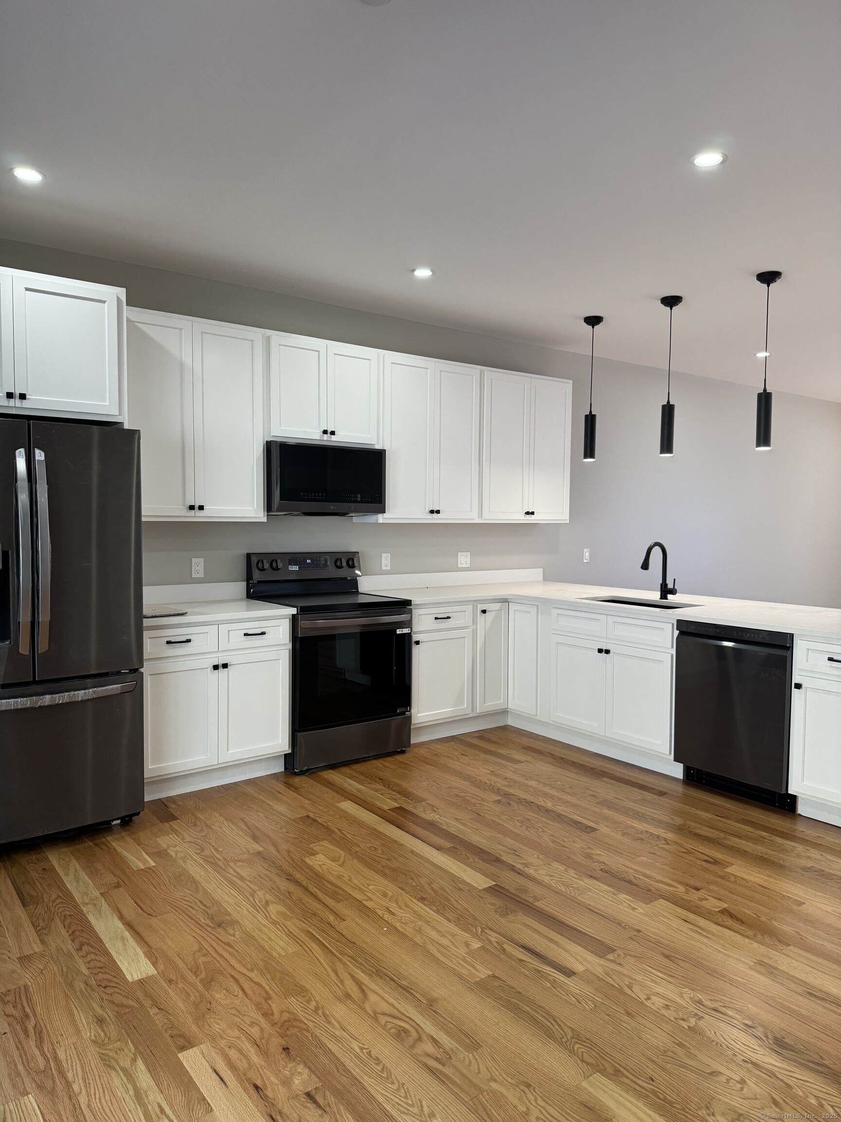 243 Echo Lake Road, Unit B8 Watertown, CT 06795 - Photo 5 of 11 a kitchen with granite countertop a refrigerator and a stove top oven