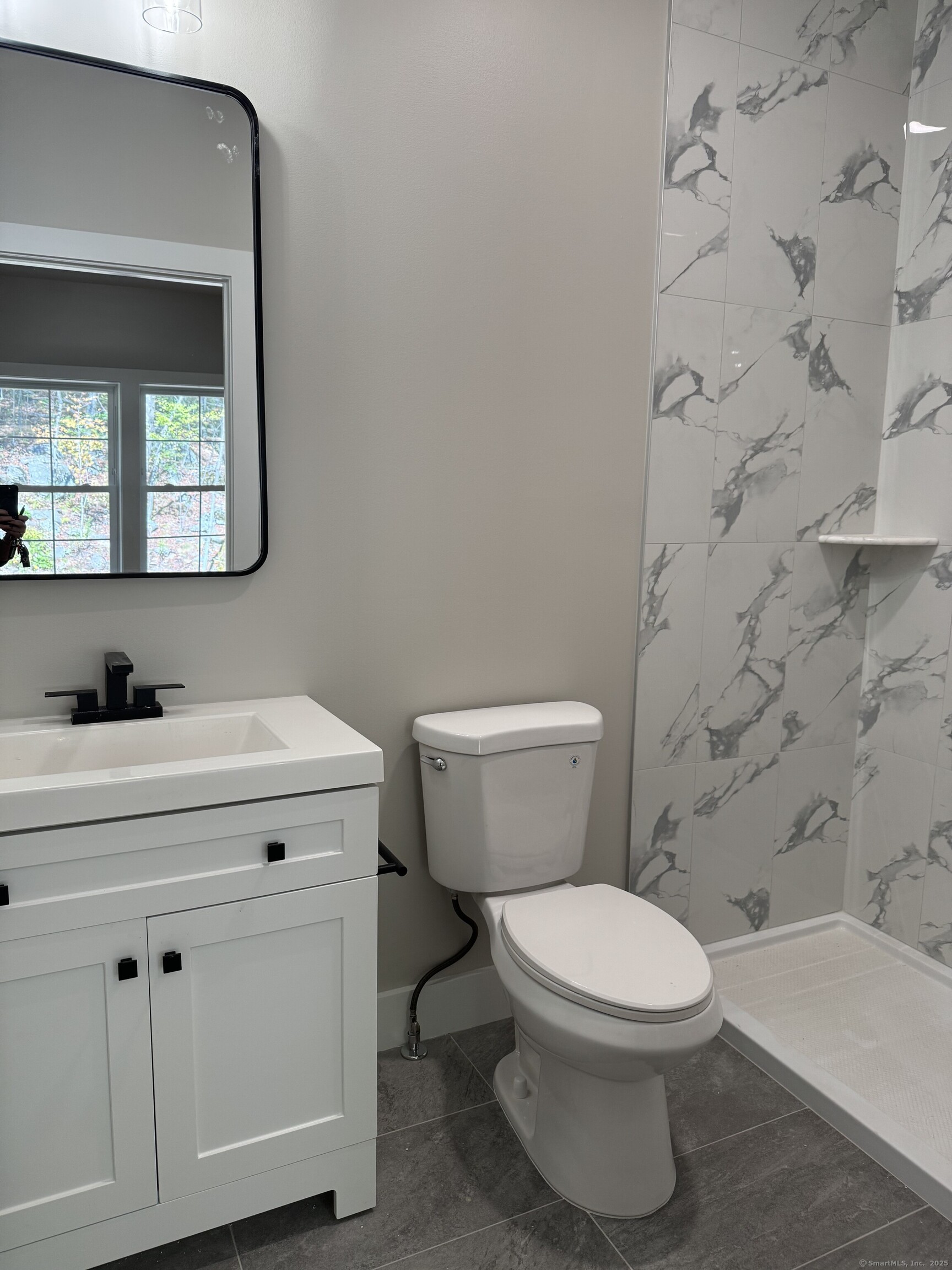 243 Echo Lake Road, Unit B8 Watertown, CT 06795 - Photo 7 of 11 a white toilet sitting next to a bathroom sink