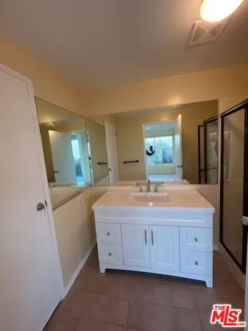 a bathroom with a sink a mirror and a vanity