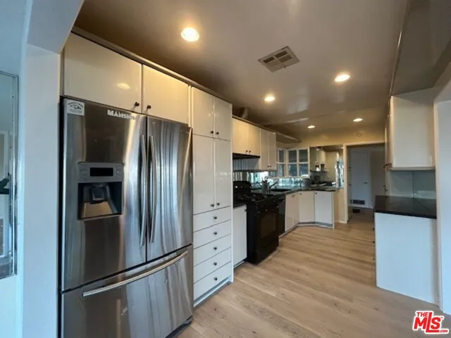 a kitchen with stainless steel appliances a refrigerator and a sink