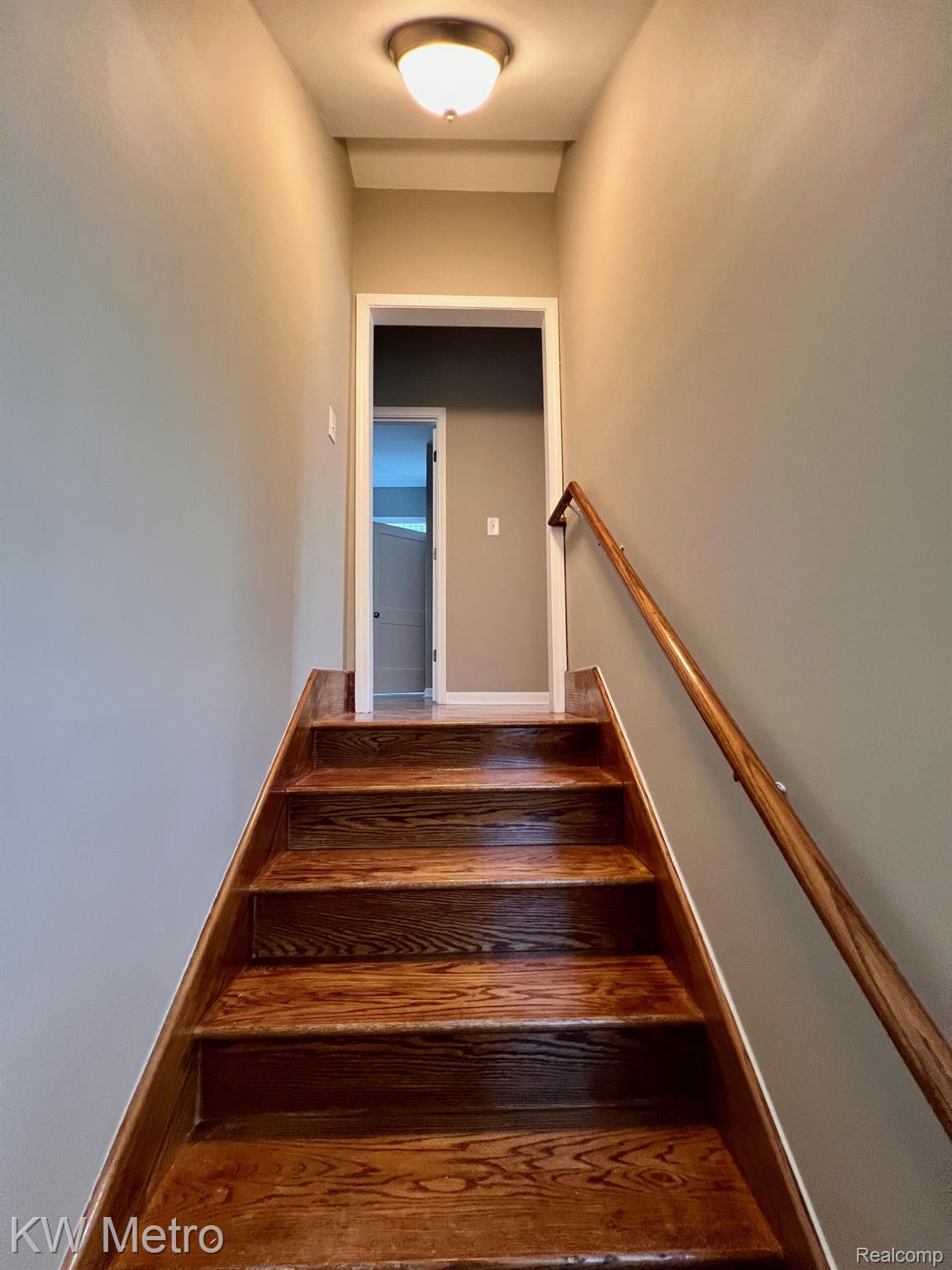 939 Webb Street Detroit, MI 48202 - Photo 8 of 19 Rich wood-finish staircase with a coordinating wood handrail