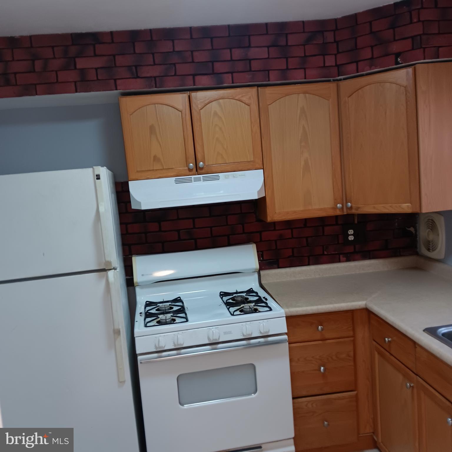 1971 Addison Road South District Heights, MD 20747 - Photo 22 of 30 a kitchen with a refrigerator and a stove