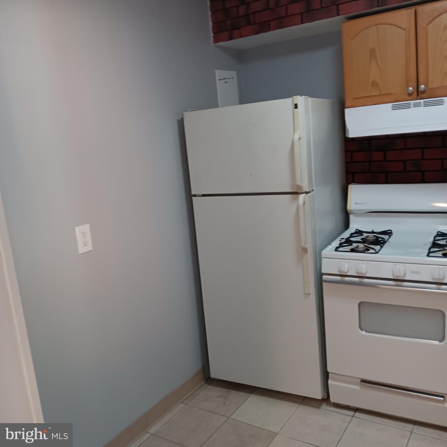 1971 Addison Road South District Heights, MD 20747 - Photo 23 of 30 a white refrigerator freezer and a stove sitting inside of a kitchen