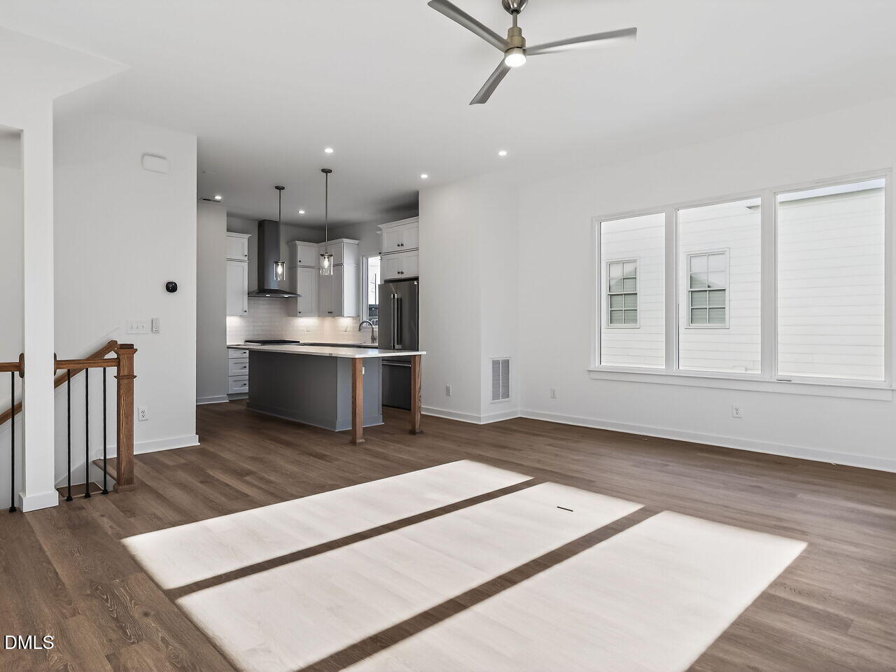 1521 Sunrise Avenue Raleigh, NC 27608 - Photo 16 of 36 a living room with stainless steel appliances kitchen island furniture and a wooden floor