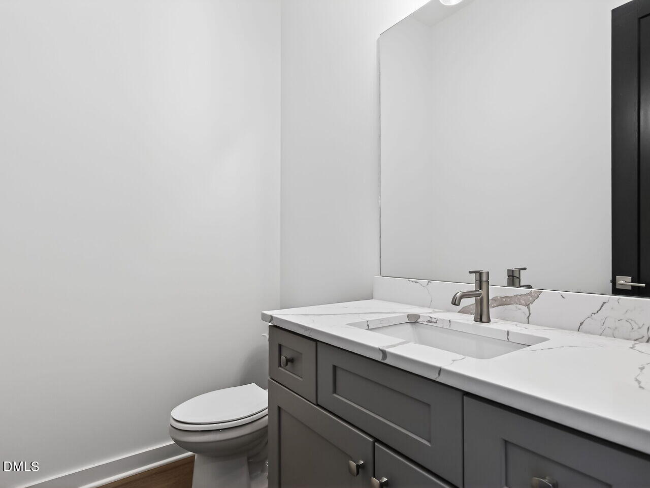 1521 Sunrise Avenue Raleigh, NC 27608 - Photo 21 of 36 a bathroom with a sink a toilet and mirror