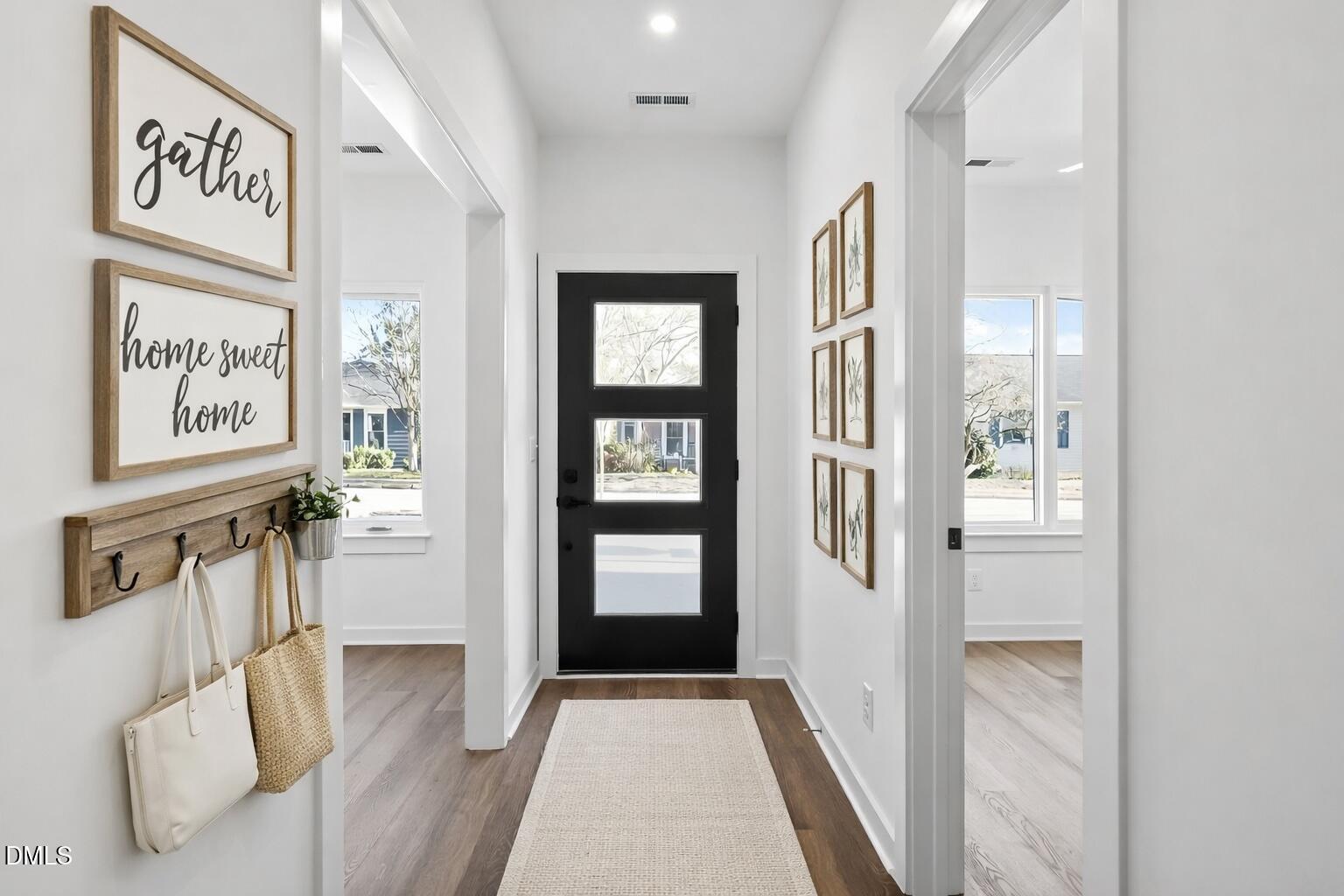 1521 Sunrise Avenue Raleigh, NC 27608 - Photo 4 of 36 a view of a hallway with windows and stairs