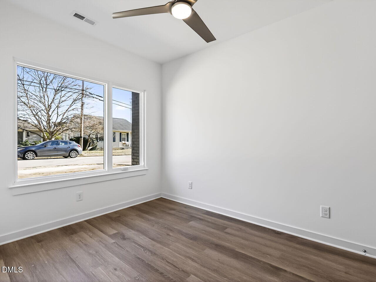 1521 Sunrise Avenue Raleigh, NC 27608 - Photo 9 of 36 an empty room with wooden floor and windows