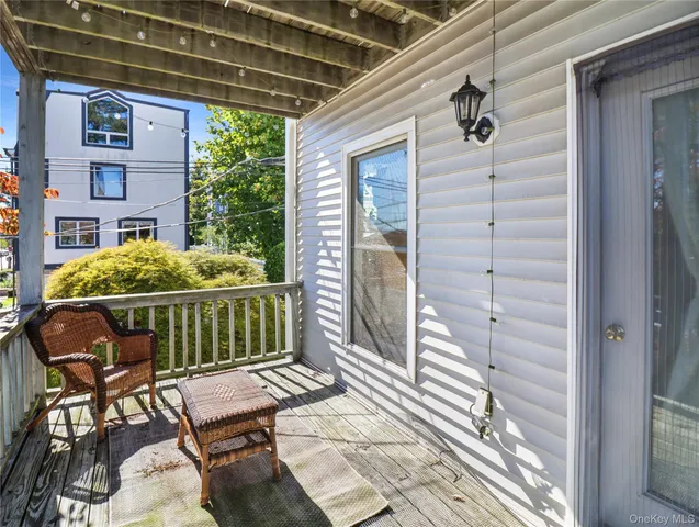a balcony with furniture and a potted plant