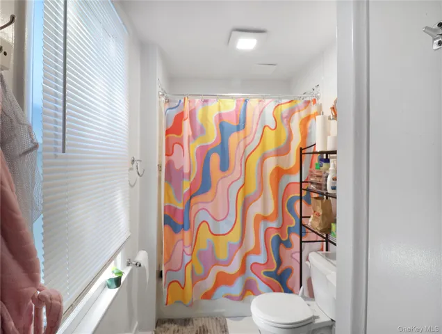 a bathroom with a shower curtain and a sink