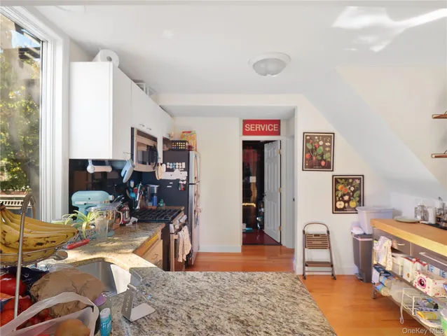 a bedroom with furniture and a wooden floor