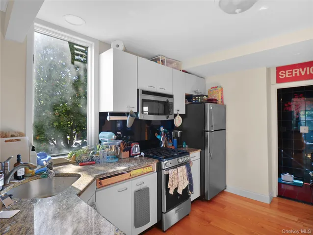 a kitchen with a refrigerator and a sink