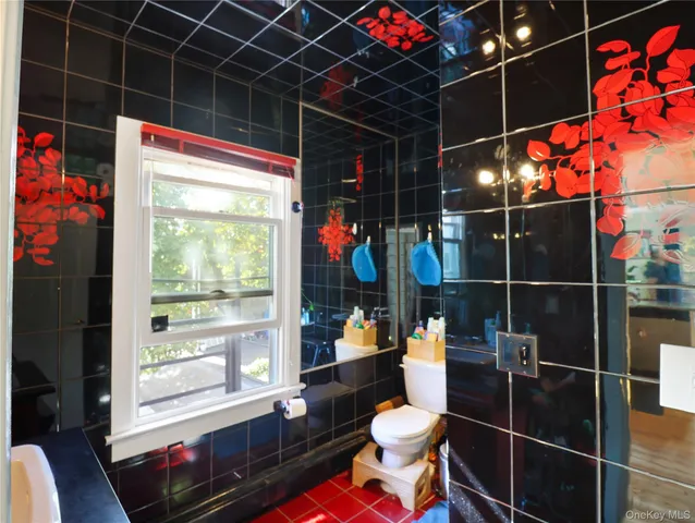 a bathroom with a toilet a sink and shower