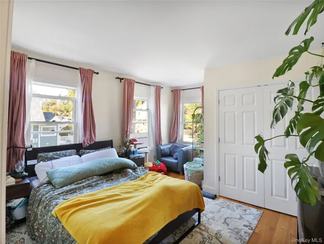 a bed sitting in a spacious bedroom next to a window