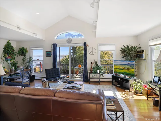 a living room with fireplace furniture and a chandelier