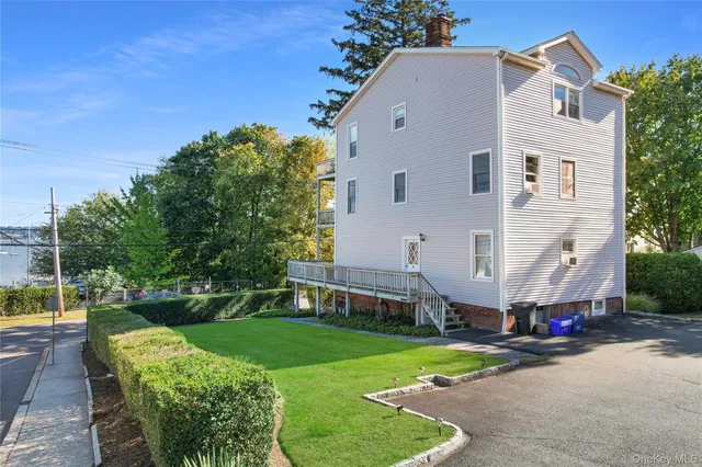 a front view of a house with a yard table and chairs