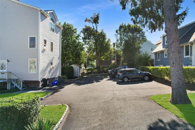 a street view with couple of cars parked on road