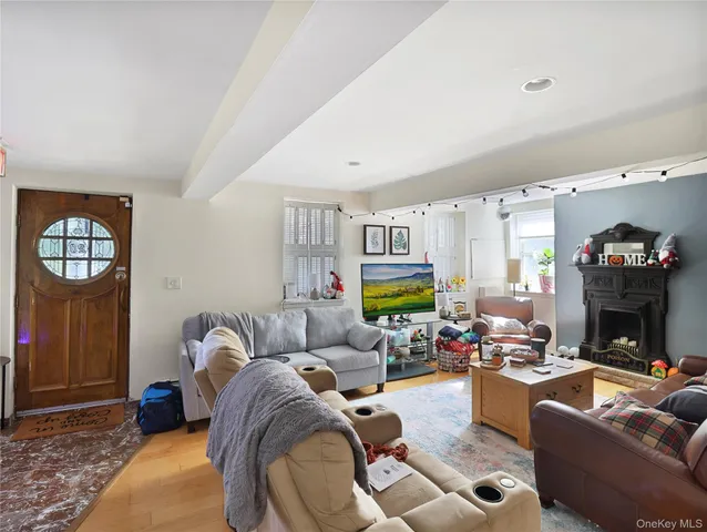 a living room with furniture fireplace and a window