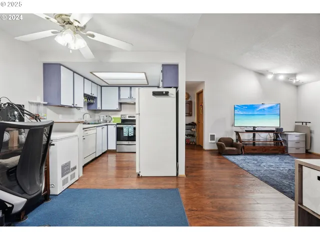a living room with stainless steel appliances kitchen island granite countertop furniture and a kitchen view