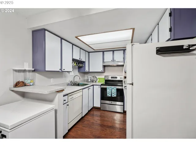 a kitchen with stainless steel appliances a sink stove and cabinets