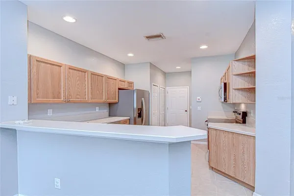 a kitchen with stainless steel appliances granite countertop a refrigerator sink and cabinets