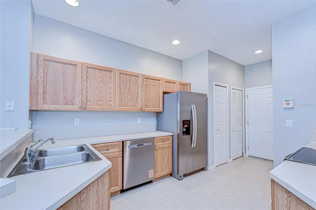 a kitchen with stainless steel appliances granite countertop white cabinets a stove a sink and dishwasher