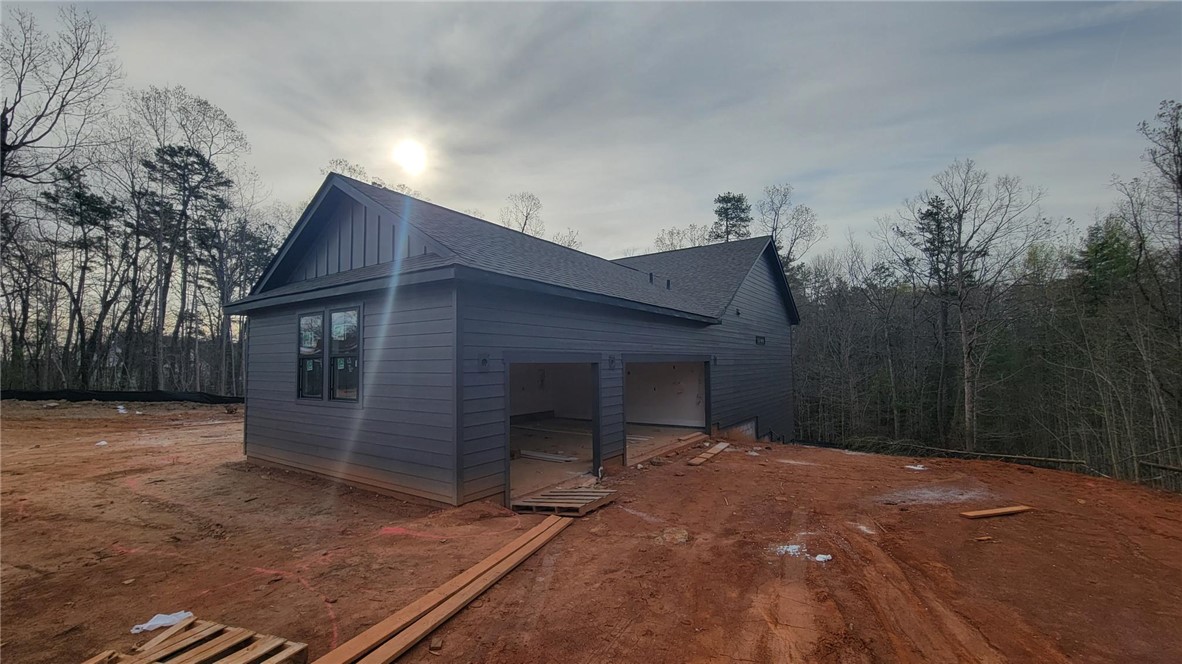 533 16th Circle Walhalla, SC 29691 - Photo 2 of 28 This newly constructed residence showcases a contemporary design with integrated garage space, nestled amidst a wooded landscape.