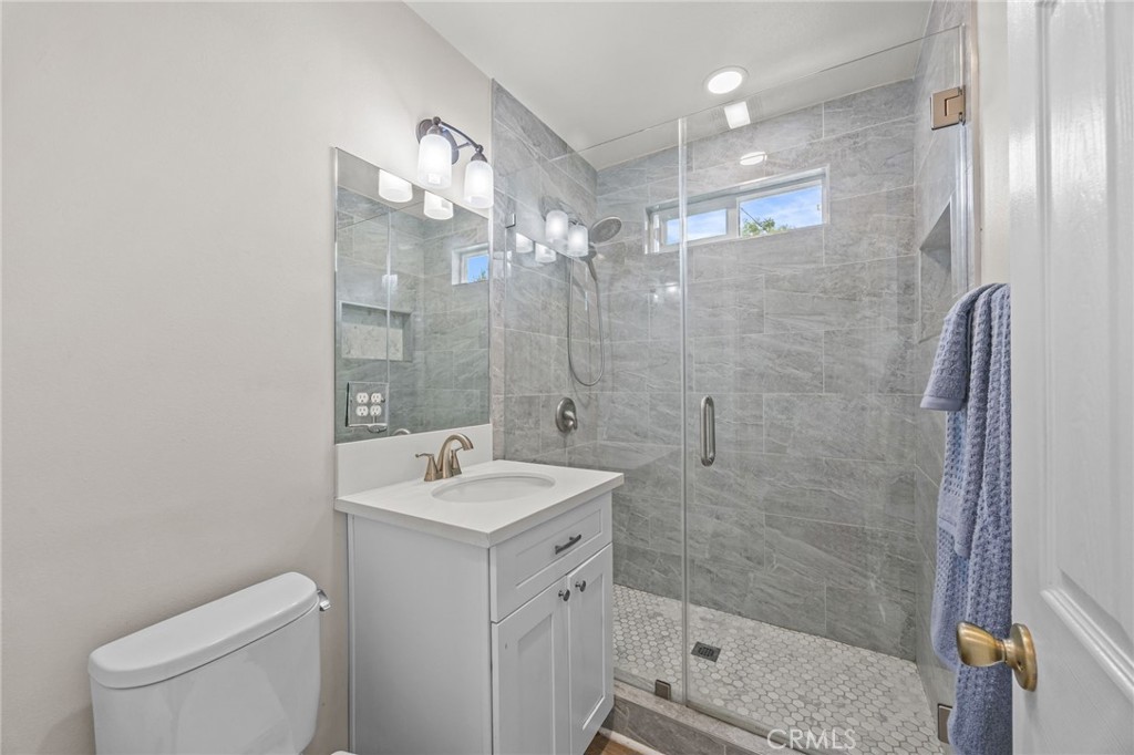 10028 Primrose Drive Riverside, CA 92503 - Photo 13 of 19 a bathroom with a sink a toilet and shower