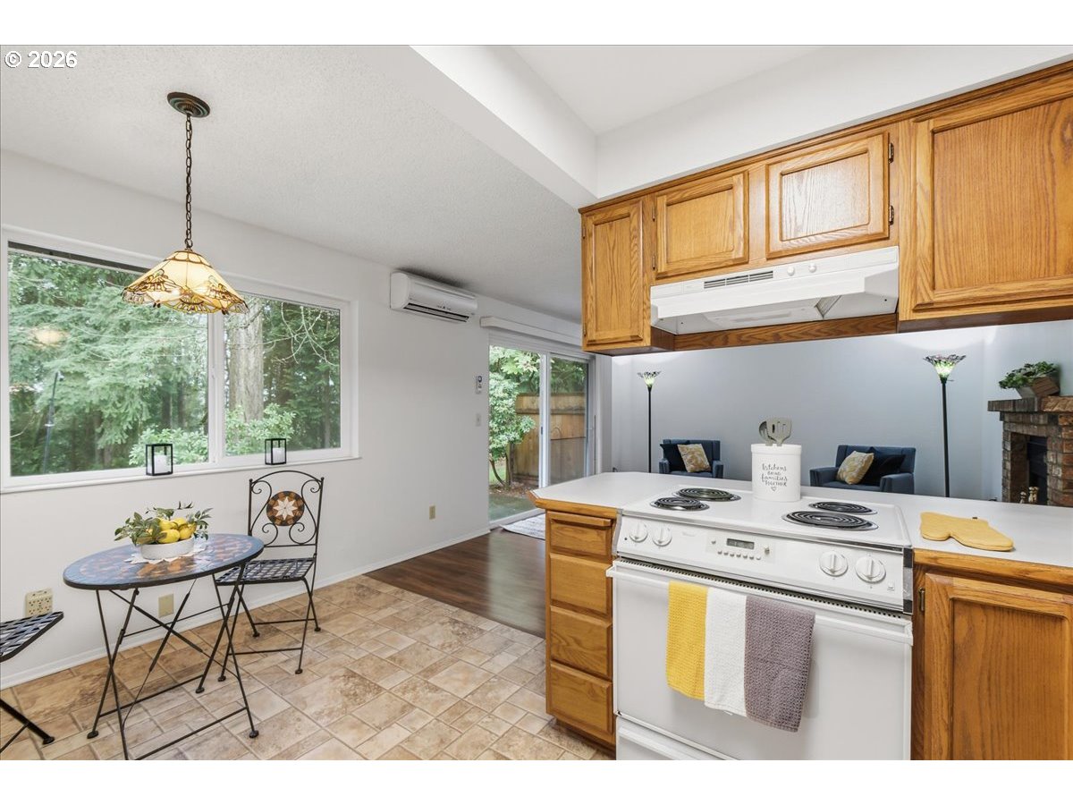 13102 Northwest 8th Way, Unit C Vancouver, WA 98685 - Photo 12 of 41 a open kitchen with stainless steel appliances kitchen island a stove a sink dishwasher and cabinets with wooden floor