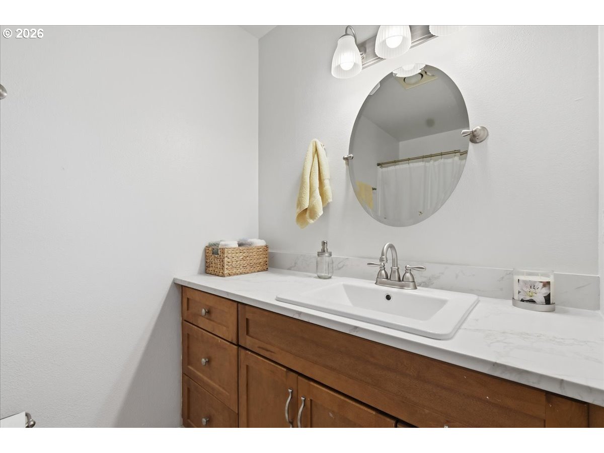 13102 Northwest 8th Way, Unit C Vancouver, WA 98685 - Photo 21 of 41 a bathroom with a sink vanity and a mirror