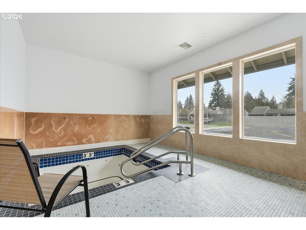 13102 Northwest 8th Way, Unit C Vancouver, WA 98685 - Photo 37 of 41 a living room with a table chairs and a window