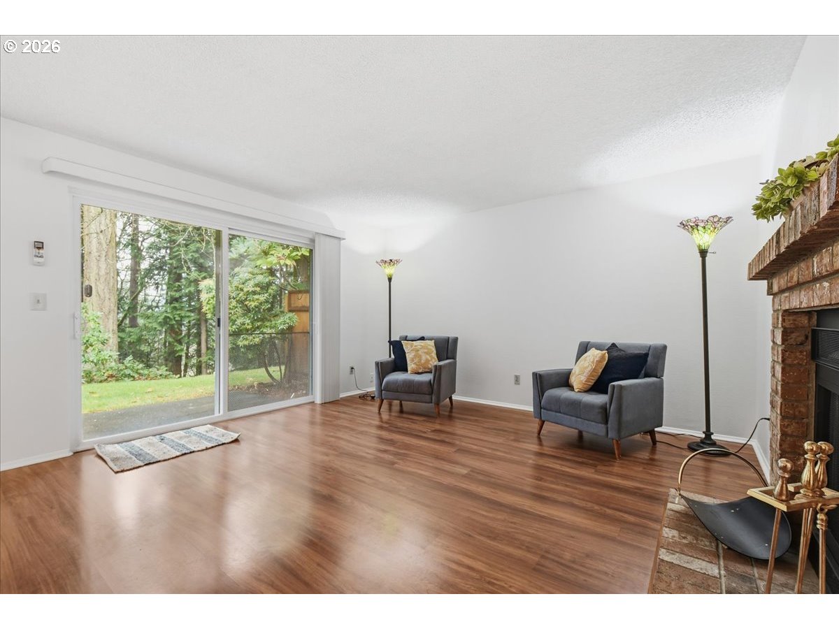 13102 Northwest 8th Way, Unit C Vancouver, WA 98685 - Photo 6 of 41 a living room with furniture and a table