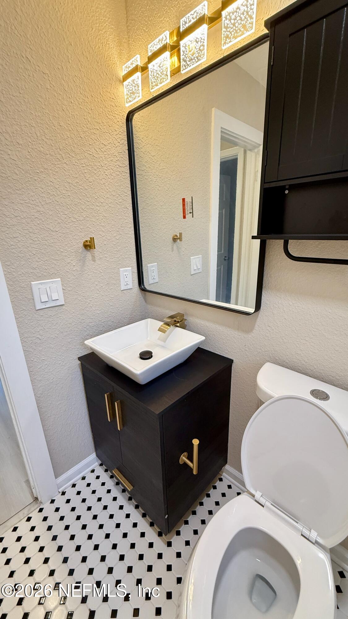 696 Kestner Road Atlantic Beach, FL 32233 - Photo 13 of 18 a bathroom with a sink a toilet and mirror
