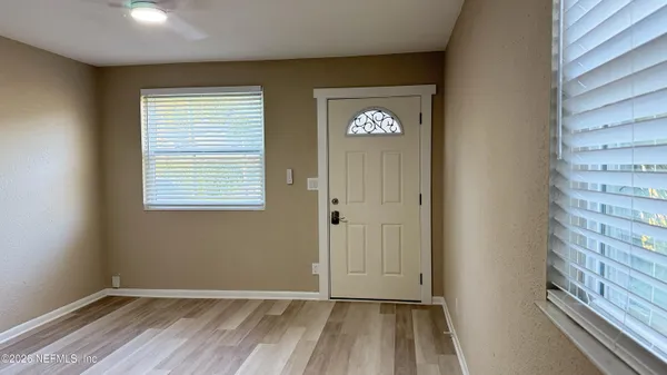 a view of a room with wooden floor