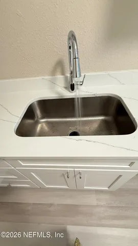 a bathroom with a sink toilet and mirror
