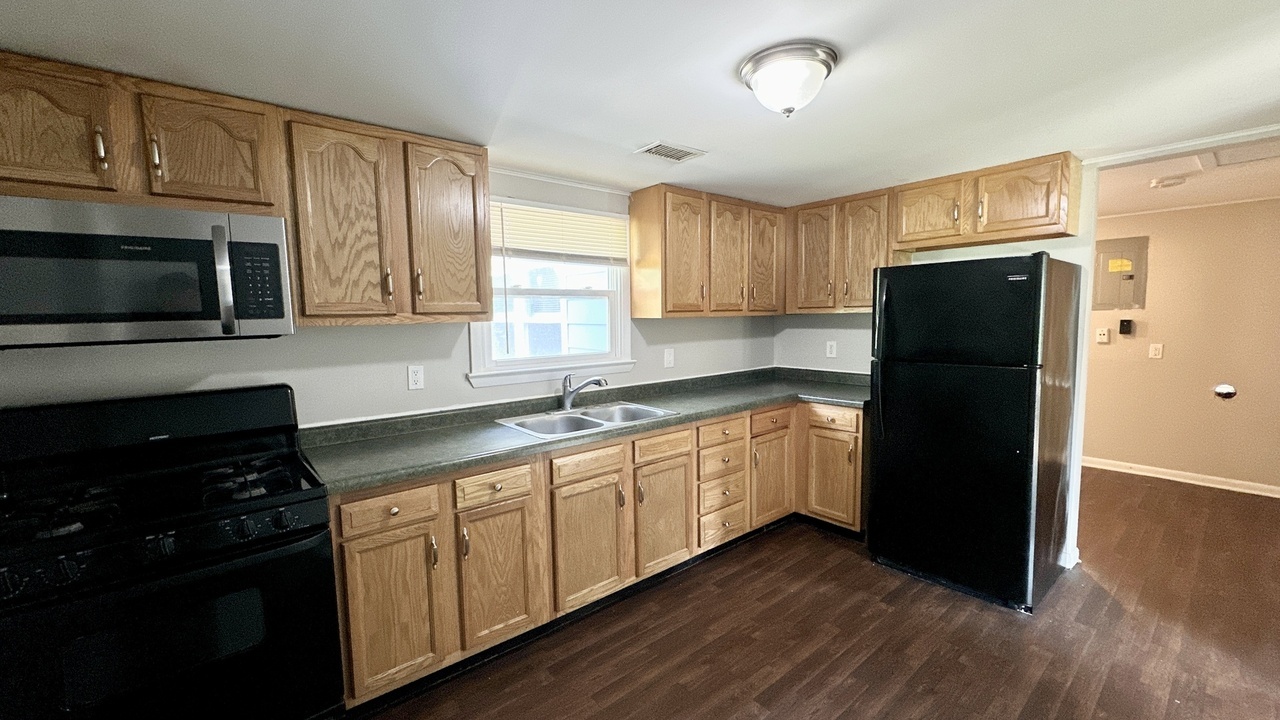 3512 John Street Steger, IL 60475 - Photo 6 of 18 a kitchen with granite countertop white cabinets and refrigerator