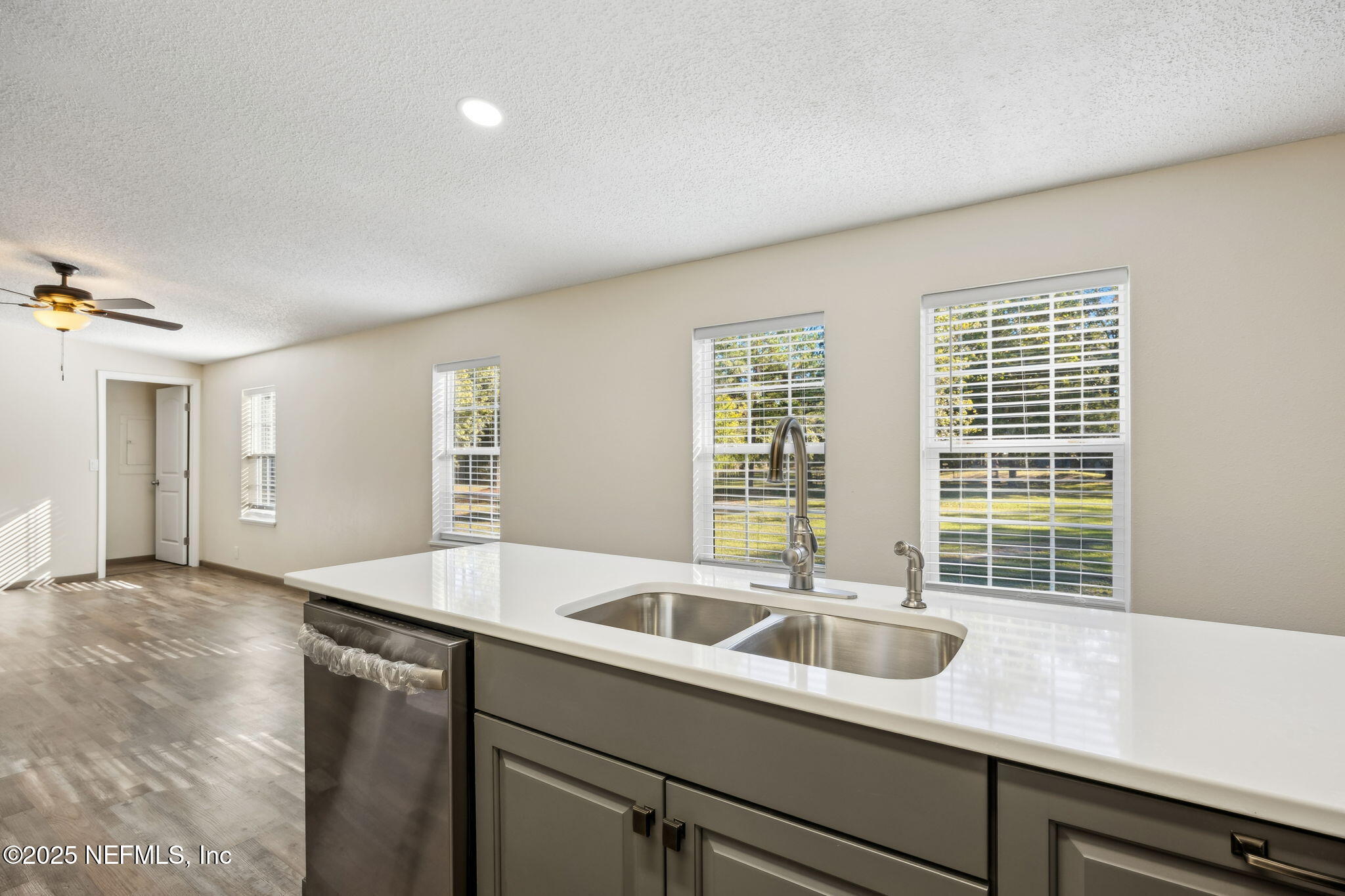 6034 Leona Padgett Road Jacksonville, FL 32234 - Photo 16 of 37 a view of a kitchen with a sink and large window