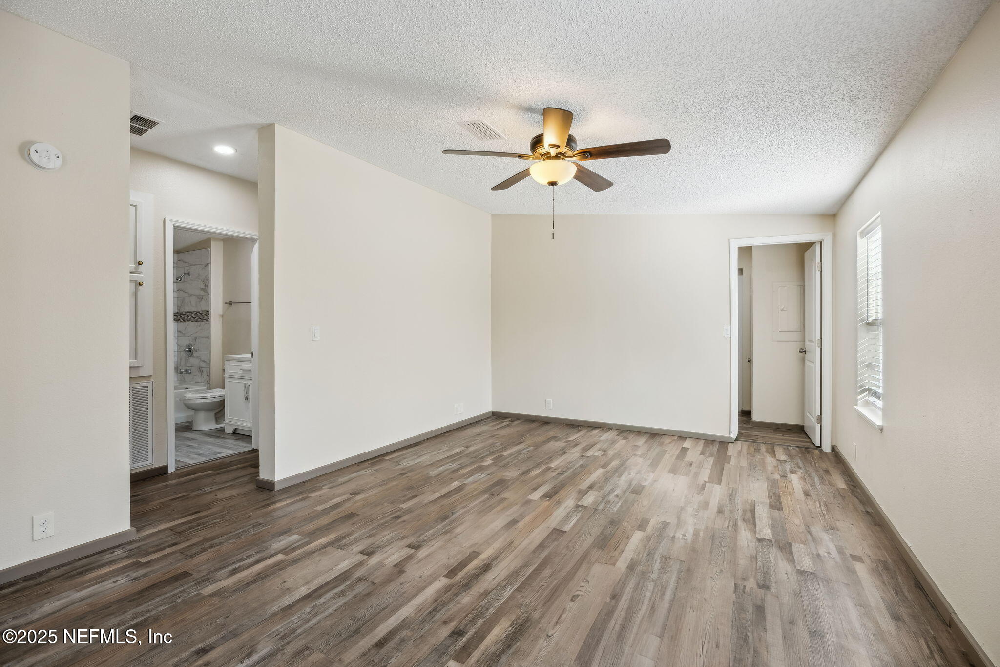 6034 Leona Padgett Road Jacksonville, FL 32234 - Photo 20 of 37 wooden floor in an empty room with a window