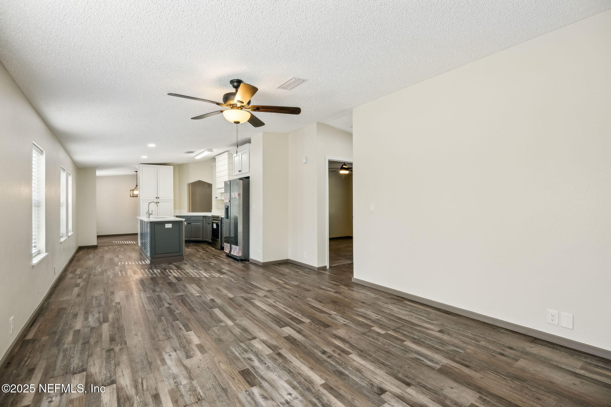 6034 Leona Padgett Road Jacksonville, FL 32234 - Photo 21 of 37 a view of a kitchen with a sink and a refrigerator